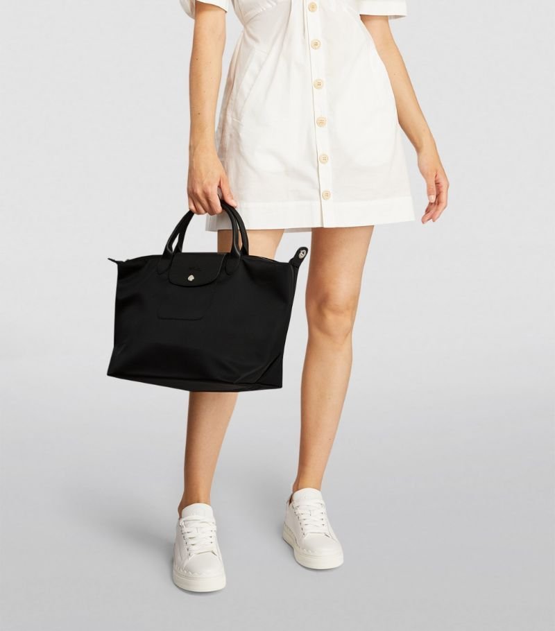 Longchamp Le Pliage Energy L handbag in black with sleek, folded design and sturdy handles, displayed on a plain background.