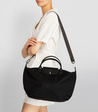 Black Longchamp Le Pliage Energy L handbag with structured design and double handles, shown on a plain background.