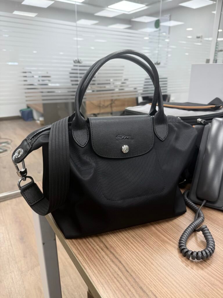 Longchamp Le Pliage Energy S handbag in black with sleek design and compact size, featuring sturdy handles and minimalist style.
