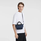 Navy Longchamp Le Pliage Energy XS handbag with structured shape and short handles, showcasing a compact, stylish design.
