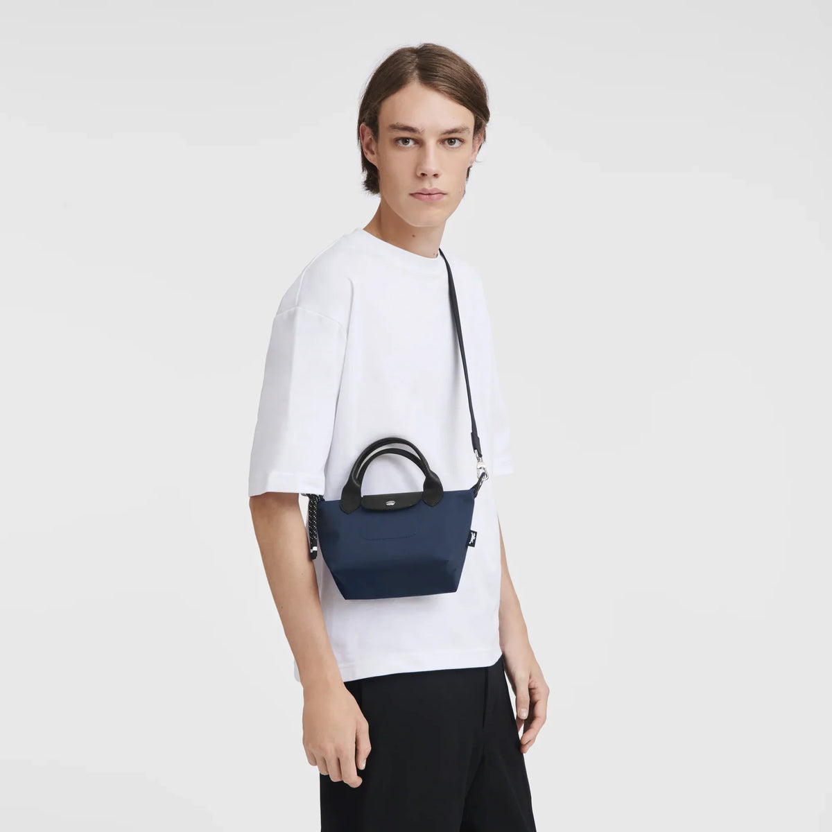 Navy Longchamp Le Pliage Energy XS handbag with structured shape and short handles, showcasing a compact, stylish design.
