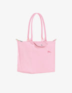 Longchamp Le Pliage Green L tote bag in pink, showcasing its spacious design and durable canvas material.