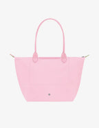 Longchamp Le Pliage green L tote bag with pink accents, showcasing its lightweight, foldable design and durable fabric.