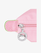 Longchamp Le Pliage Green L Tote bag in pink fabric with handles, showcasing its spacious design and sleek style.
