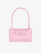 Longchamp Le Pliage Green L Tote bag in pink fabric, showcasing its spacious design and sturdy handles.