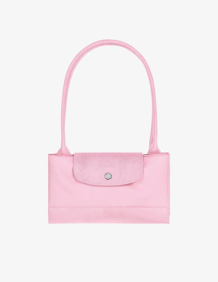 Longchamp Le Pliage Green L Tote bag in pink fabric, showcasing its spacious design and sturdy handles.