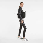 Longchamp Le Pliage Green M Tote bag in black, showing the foldable fabric bag with leather handles and logo detail.