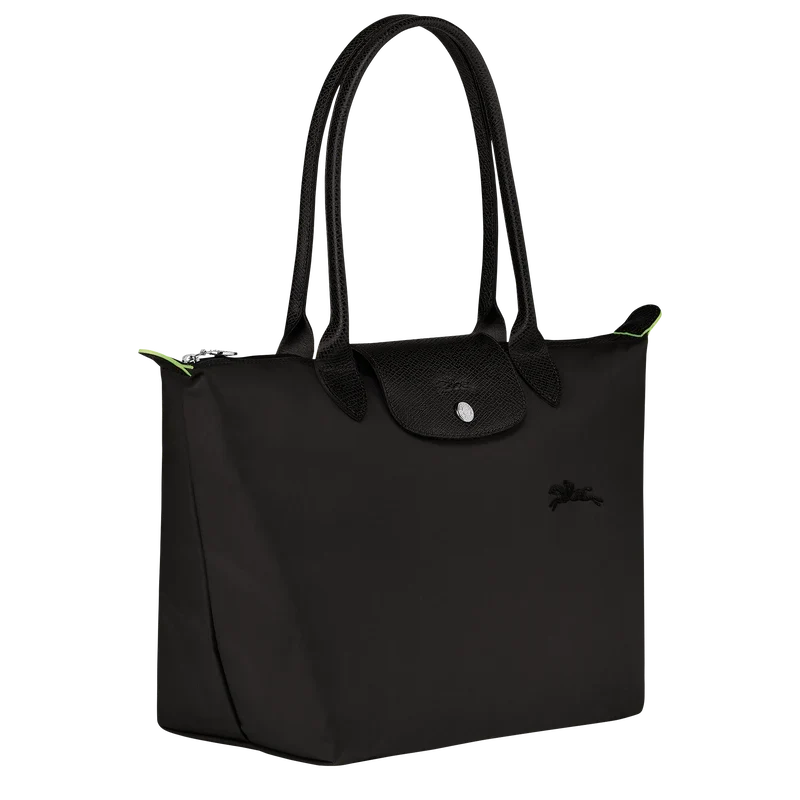 Longchamp Le Pliage Green M tote bag in black, showing the foldable nylon exterior and sturdy handles.