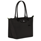 Longchamp Le Pliage Green M tote bag in black, showing the foldable nylon exterior and sturdy handles.