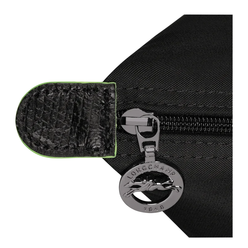 Longchamp Le Pliage Green M tote bag in black, showcasing the fabric texture and classic design with leather handles.