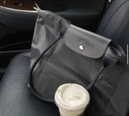 Longchamp Le Pliage Green M tote bag in black, showing the foldable design and durable fabric with black handles.