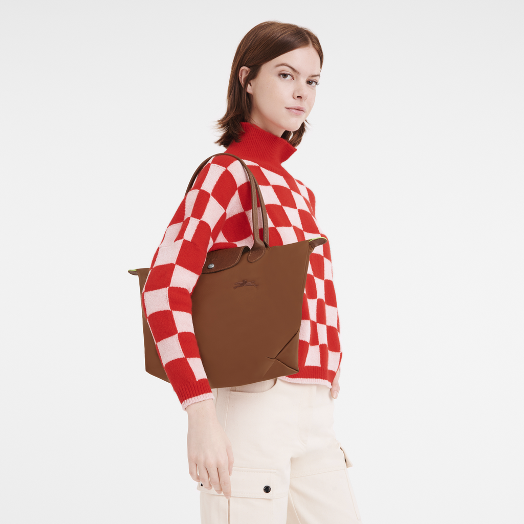 Longchamp Le Pliage Green M tote bag in Cognac color, showing the classic foldable design and sturdy handles.