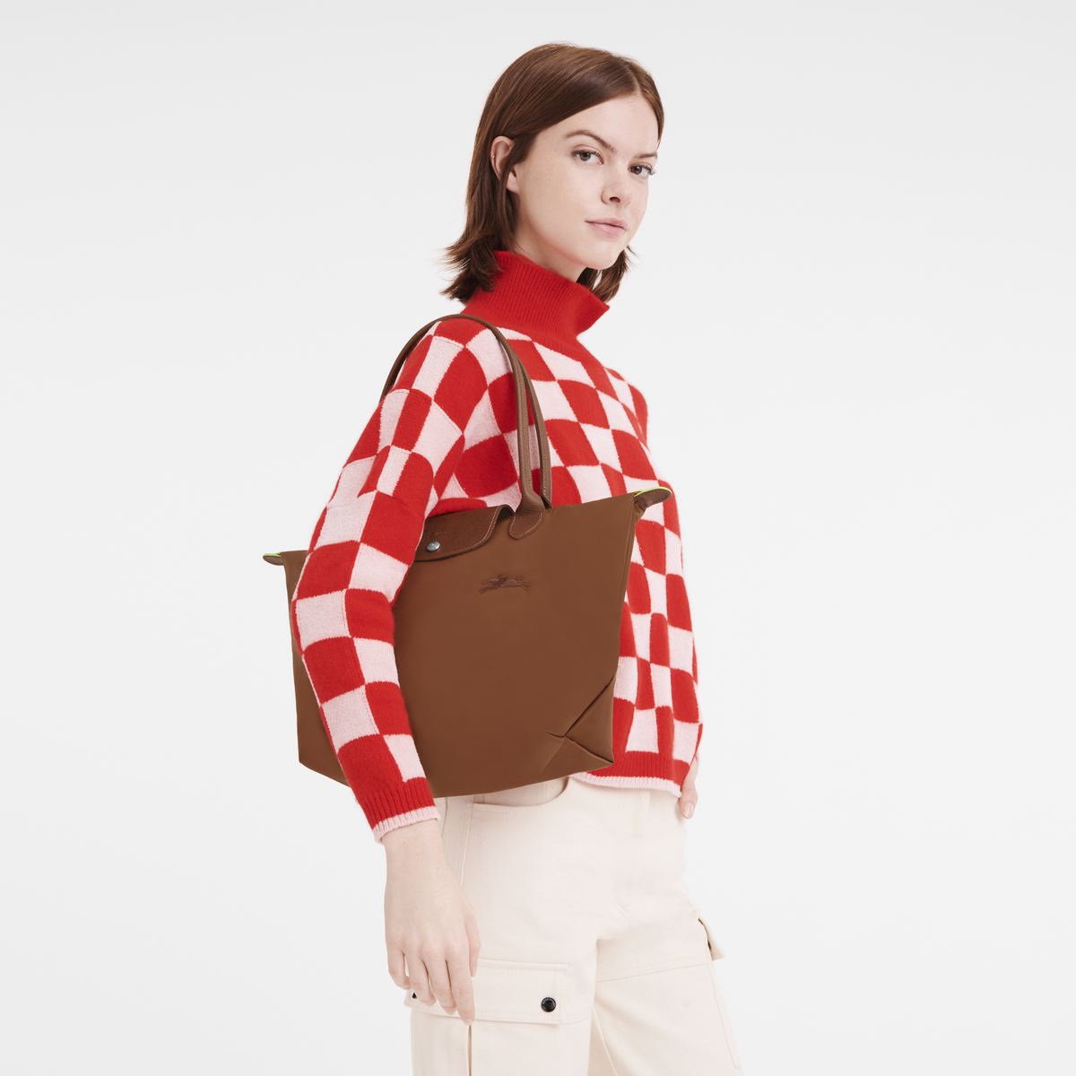 Longchamp Le Pliage Green M tote bag in Cognac color, showing the classic foldable design and sturdy handles.