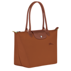 Longchamp Le Pliage Green M Tote bag in Cognac color, showing the lightweight, foldable design with sturdy handles.