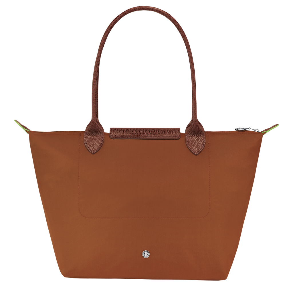 Longchamp Le Pliage green M tote bag with cognac handles, featuring a sleek, foldable design and durable fabric.