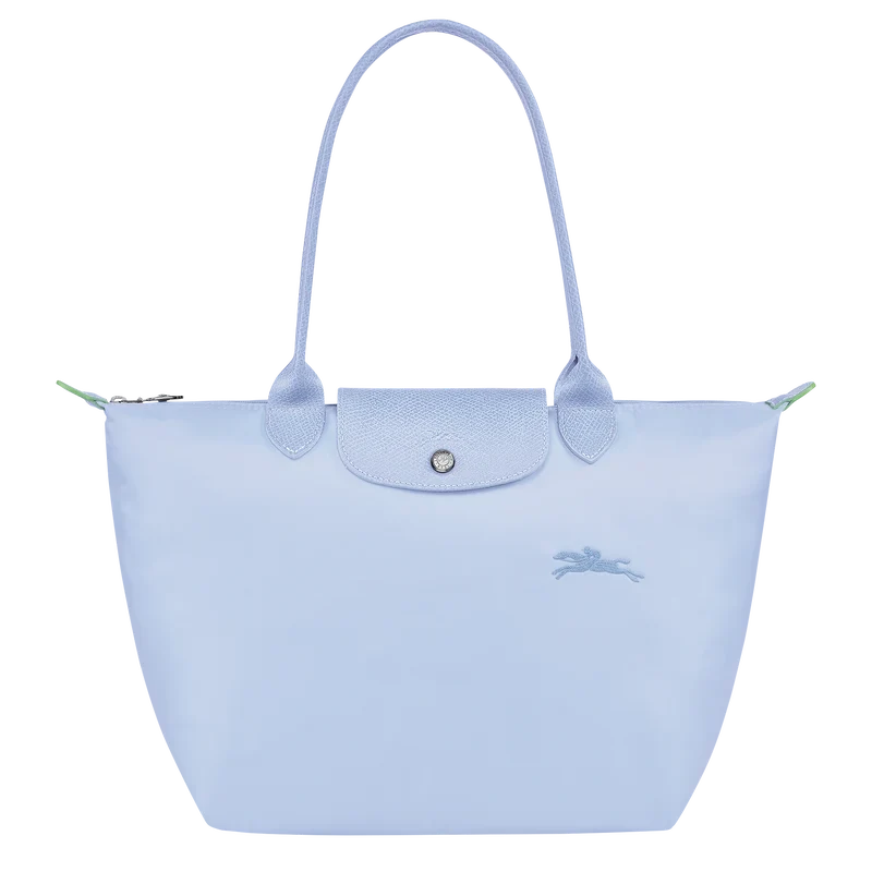 Longchamp Le Pliage Green M tote bag with sky blue accents, showcasing its lightweight, foldable design and durable fabric.