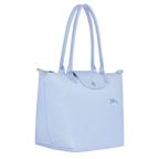 Longchamp Le Pliage Green M tote bag in sky blue, lightweight and foldable, with durable fabric and leather handles.