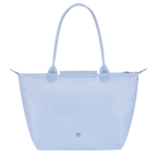 Longchamp Le Pliage Green M tote bag in sky blue fabric, showcasing its lightweight, foldable design and sturdy handles.