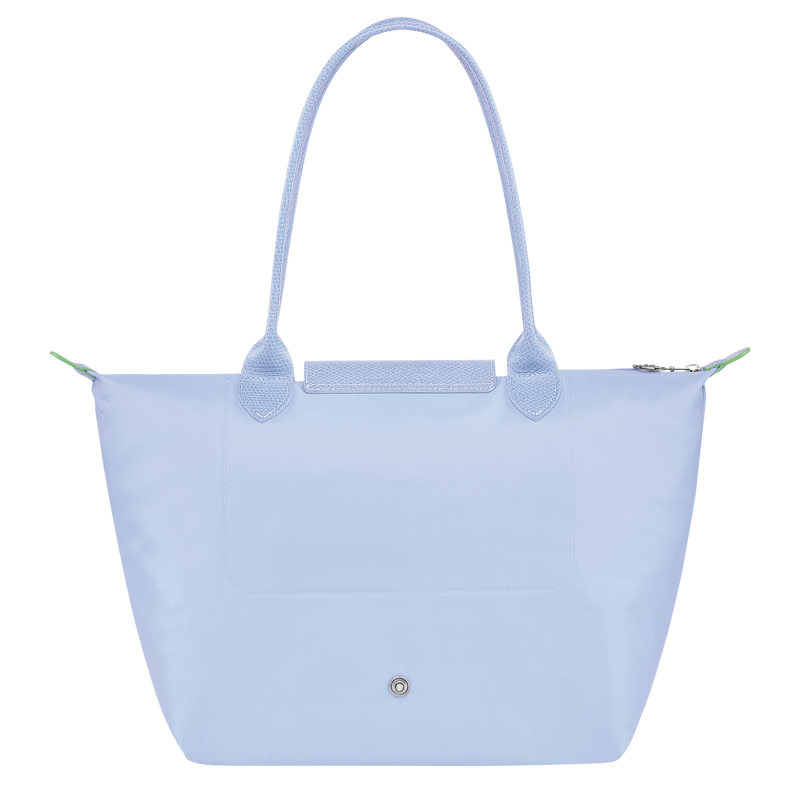 Longchamp Le Pliage Green M tote bag in sky blue fabric, showcasing its lightweight, foldable design and sturdy handles.