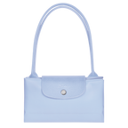 Longchamp Le Pliage Green M Tote bag in sky blue fabric with leather handles, shown open with interior details.