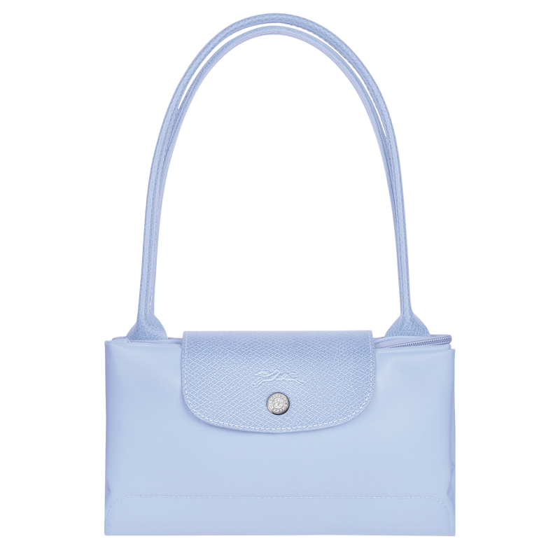 Longchamp Le Pliage Green M Tote bag in sky blue fabric with leather handles, shown open with interior details.
