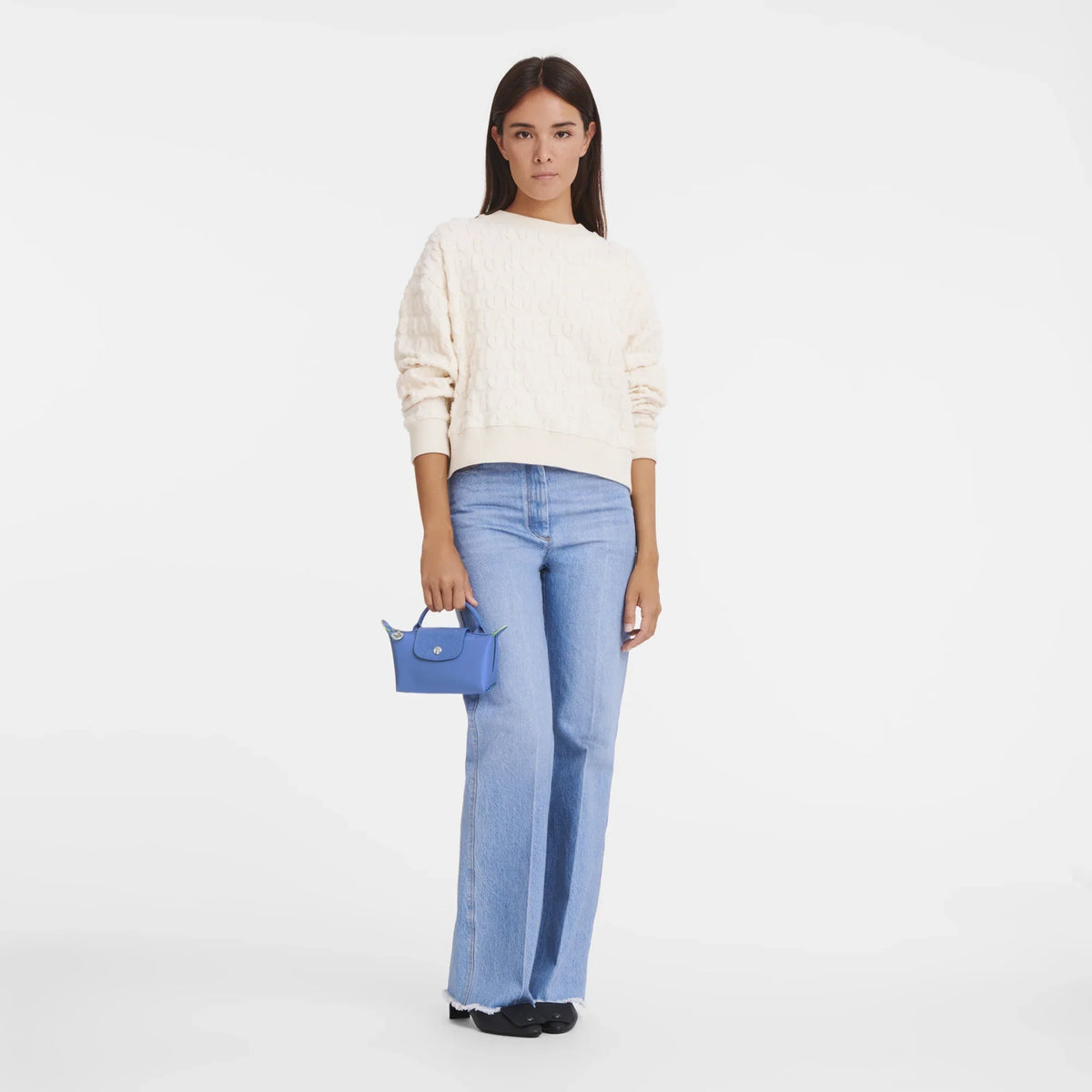 Longchamp Le Pliage green pouch bag with handle and cornflower blue accents, lightweight and versatile accessory.