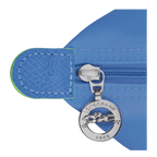 Longchamp Le Pliage green pouch with handle, featuring a cornflower blue color, compact bag with a sleek design and fabric texture.