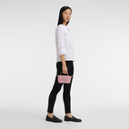 Longchamp Le Pliage green pouch with handle and petal pink accents, compact bag with a sleek design and durable material.