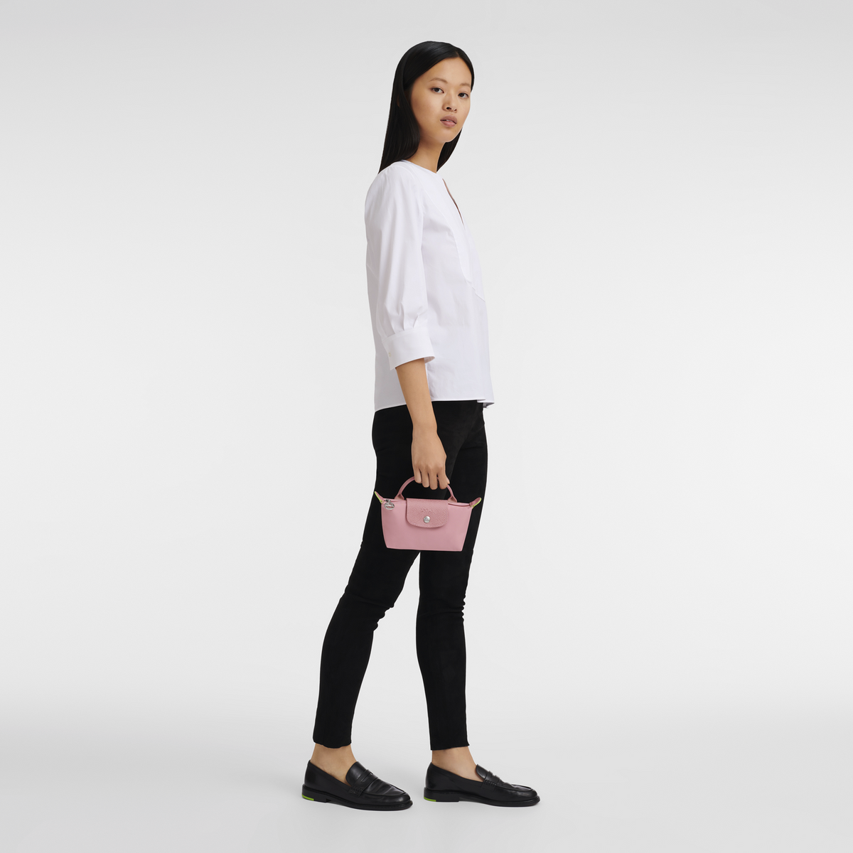 Longchamp Le Pliage green pouch with handle and petal pink accents, compact bag with a sleek design and durable material.