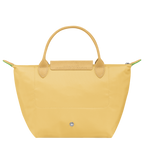 Longchamp Le Pliage Green S handbag in wheat color, featuring a compact bag design with handles, on a plain background.