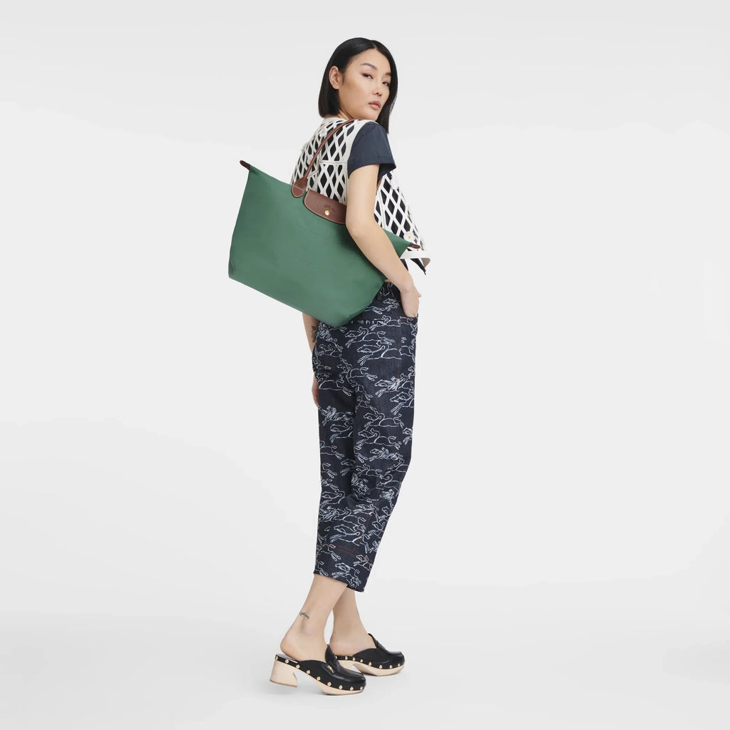 Longchamp Le Pliage Original L tote bag in sage green, lightweight nylon with leather handles and foldable design.