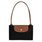 Longchamp Le Pliage Original M Tote Bag in black, showing the durable nylon material and classic design with leather handles.