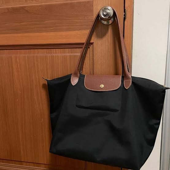 Longchamp Le Pliage Original M Tote Bag in black, showing its sleek design and durable fabric on a neutral background.