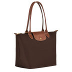 Longchamp Le Pliage Original M Tote bag in ebony with nylon and leather handles, showcasing its compact, foldable design.