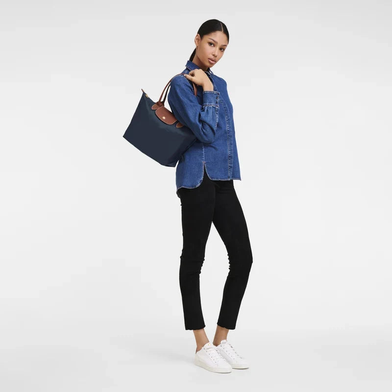 Longchamp Le Pliage Original M tote bag in navy, showcasing durable nylon material and leather handles.