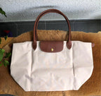 Longchamp Le Pliage Original M tote bag in wine paper material, showing the lightweight, foldable design and classic style.