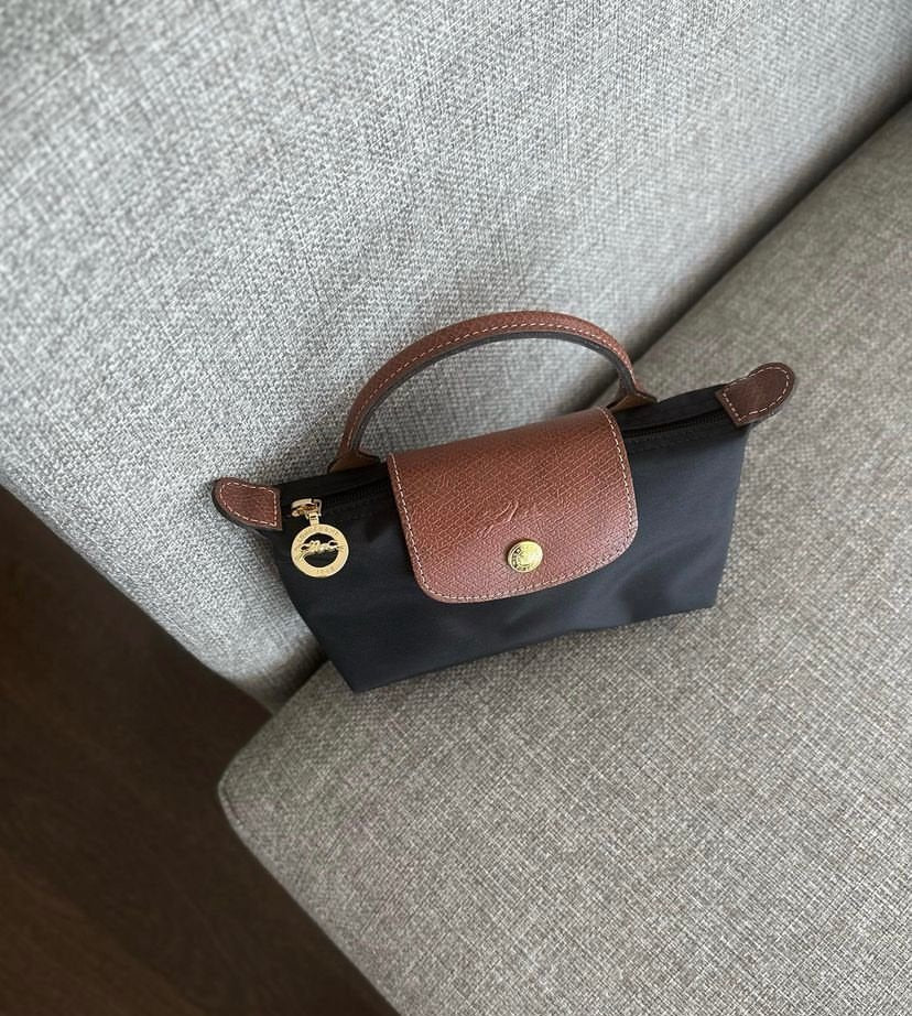 Black Longchamp Le Pliage Original pouch with handle, showcasing a compact and versatile bag design for everyday use.