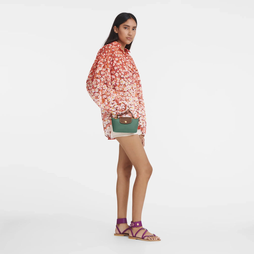 Longchamp Le Pliage Original Pouch with handle in sage green, showing its compact design and durable fabric.