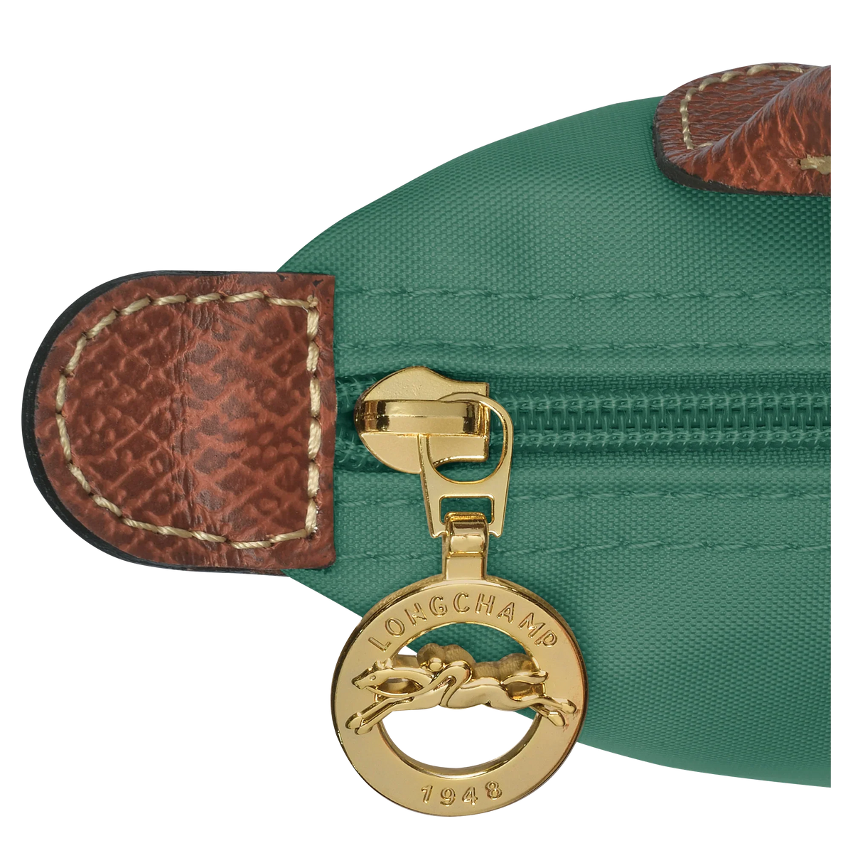 Longchamp Le Pliage Original Pouch with handle in sage green, showcasing compact bag with leather accents and fabric body.