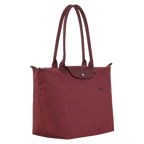 Longchamp Le Pliage Green L Tote Bag featuring a pomegranate design, showcasing its spacious fabric and sturdy handles.