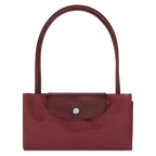 Longchamp Le Pliage Green M Tote Bag featuring pomegranate-colored durable fabric and sturdy handles for versatile carrying.
