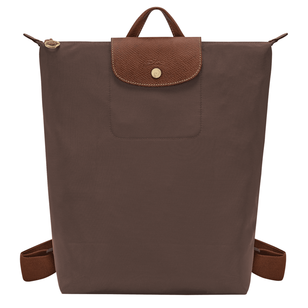 Longchamp Le Pliage Original M backpack in beige fabric with leather handles and logo detail, showing front view.