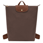 Longchamp Le Pliage Original M backpack in beige fabric with leather handles and logo detail, showing front view.
