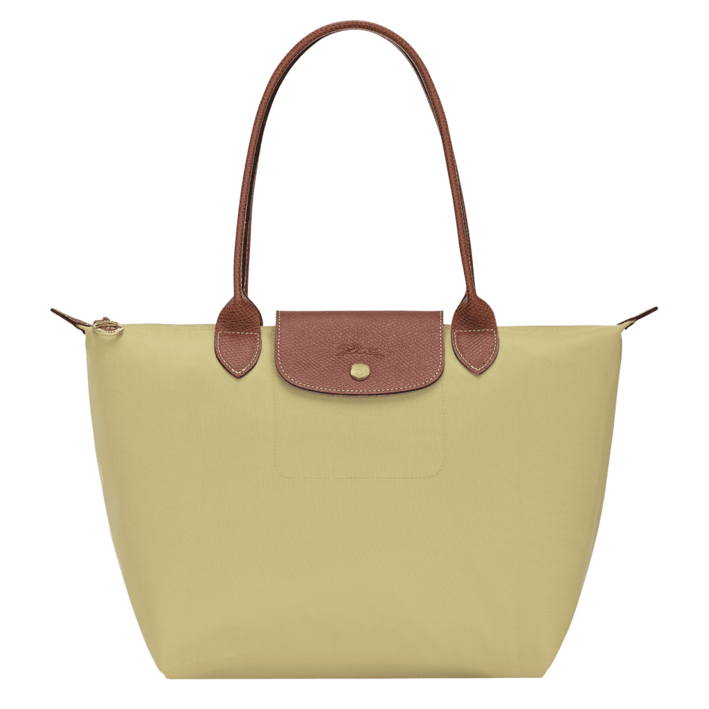 Longchamp Le Pliage Original M tote bag with beige nylon body and brown leather handles, showcasing its classic design.