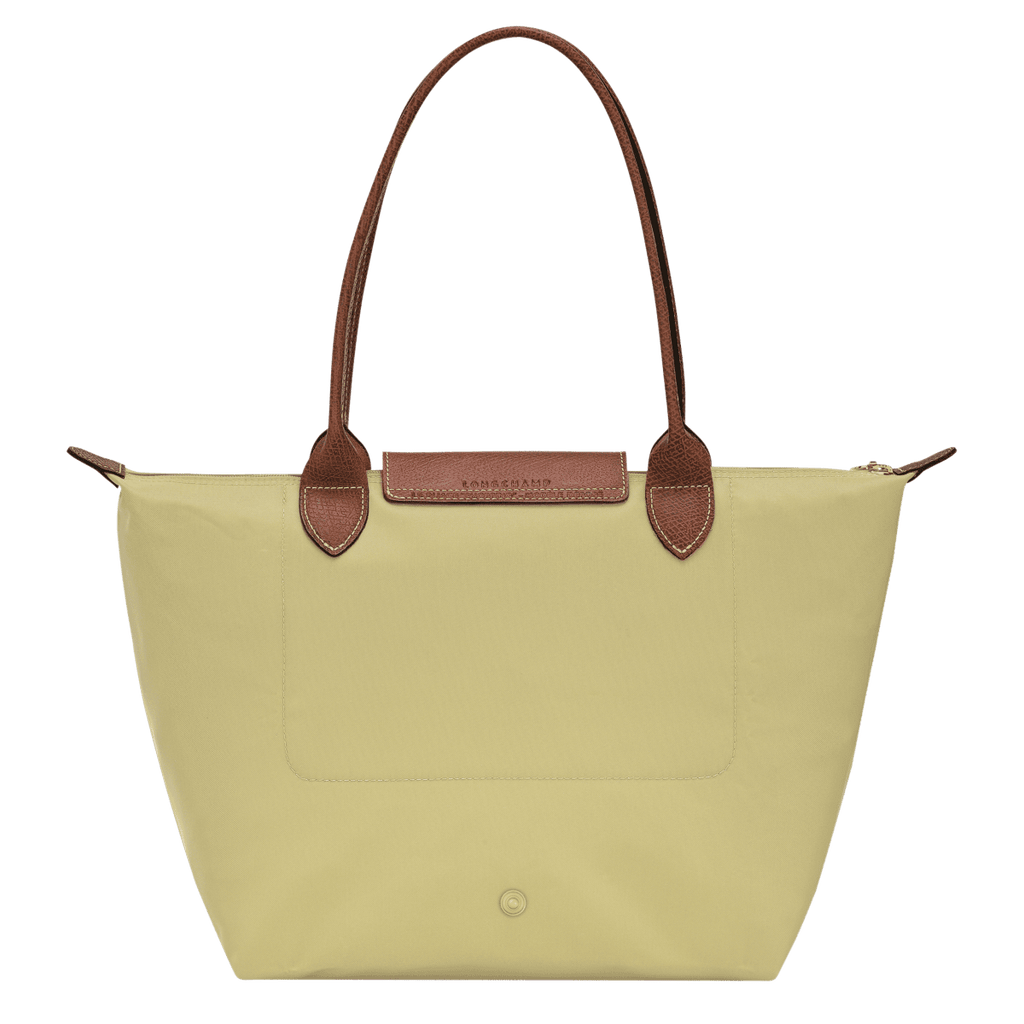Longchamp Le Pliage Original M tote bag in beige nylon with leather handles, shown open with interior details visible.