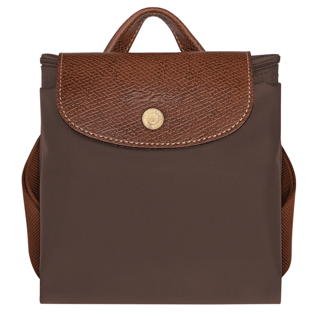 Longchamp Le Pliage Original M backpack in nylon with leather handles, shown in a side view with open top and strap details.