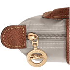 Longchamp Le Pliage Original Pouch with handle, lightweight beige bag with leather accents and sturdy top handle.