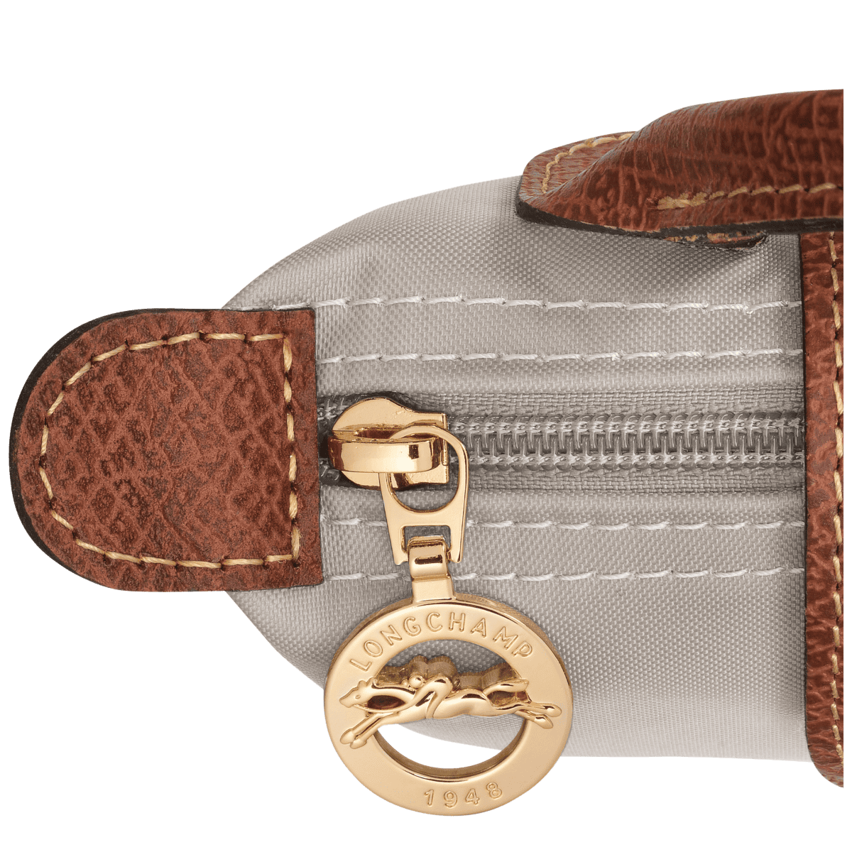 Longchamp Le Pliage Original Pouch with handle, lightweight beige bag with leather accents and sturdy top handle.